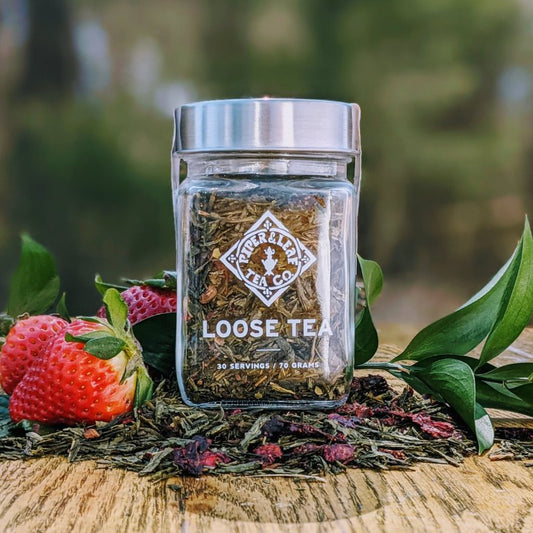 A Sassyfras Strawberry Glass Jar of Loose Leaf Tea from Piper & Leaf Tea Co. with strawberries flavored Sencha tea.