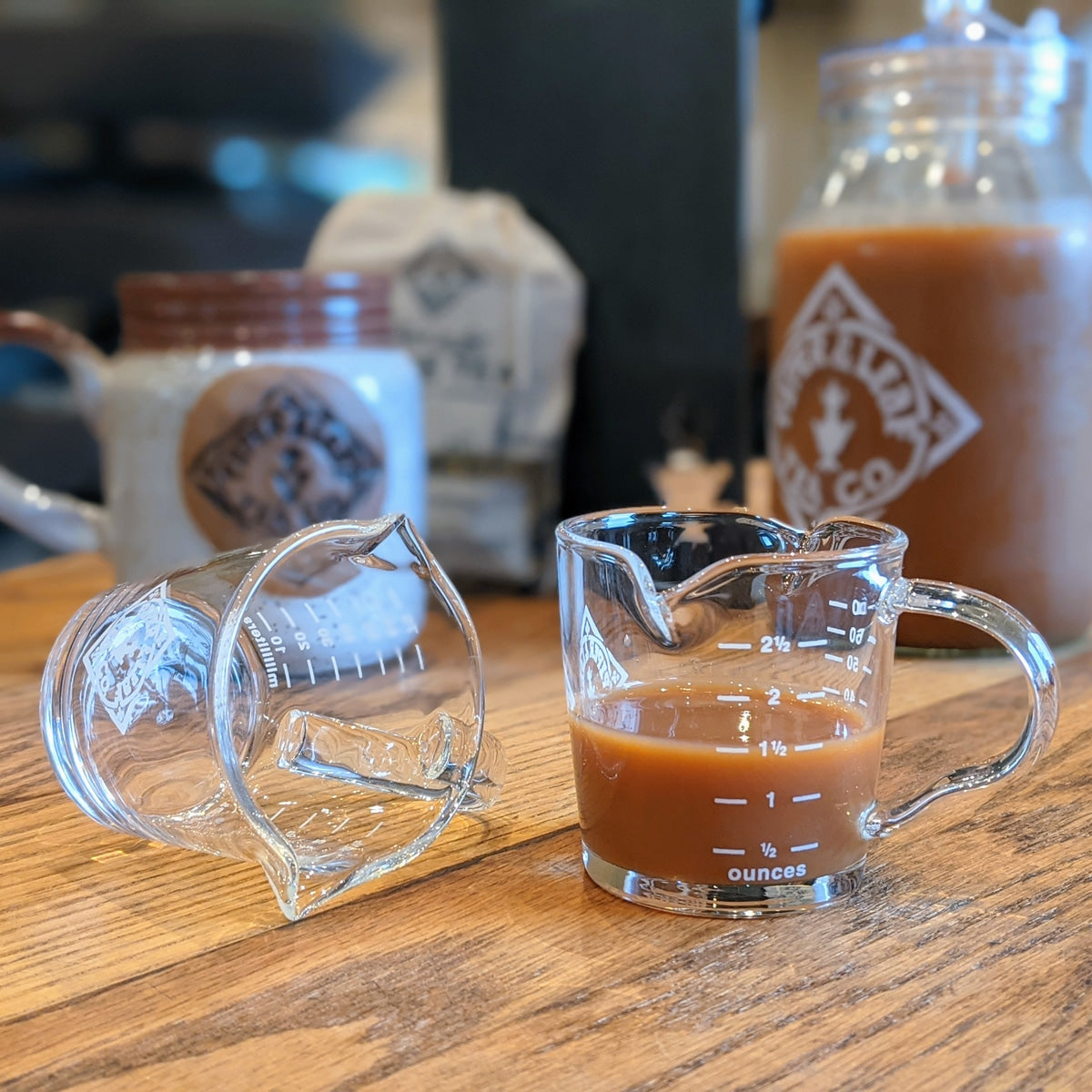 Piper Mini Measure - a tiny glass measuring cup with a little handle. Printed with the Piper & Leaf logo and measurements up to 2.5oz or 70ml